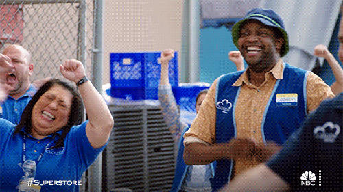 GIF from Superstore featuring cheering employees in blue shirts