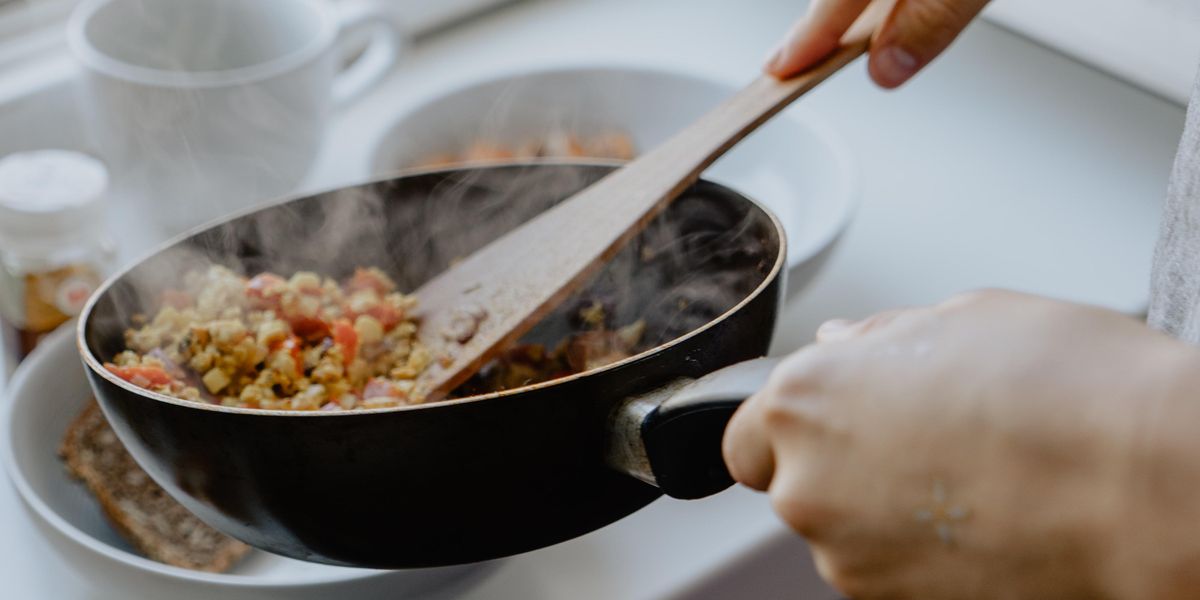 Scrambled tofu and veggies in black pan