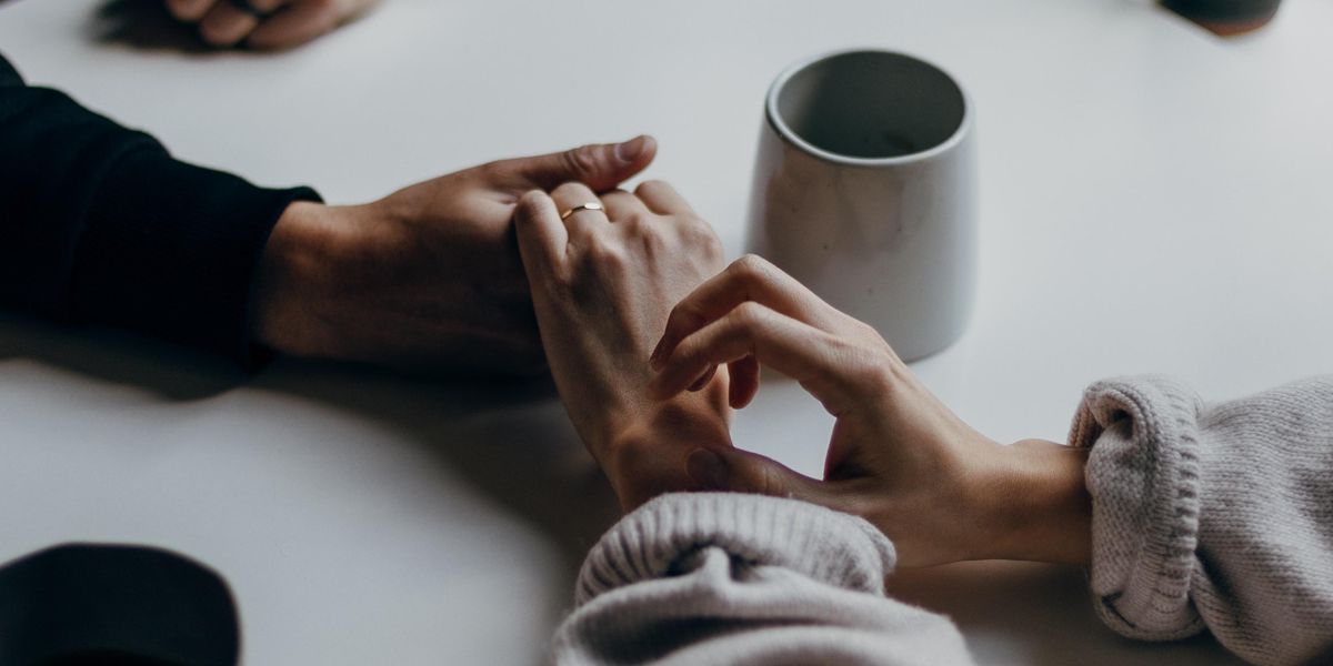 Couple holding hands at a coffee shop