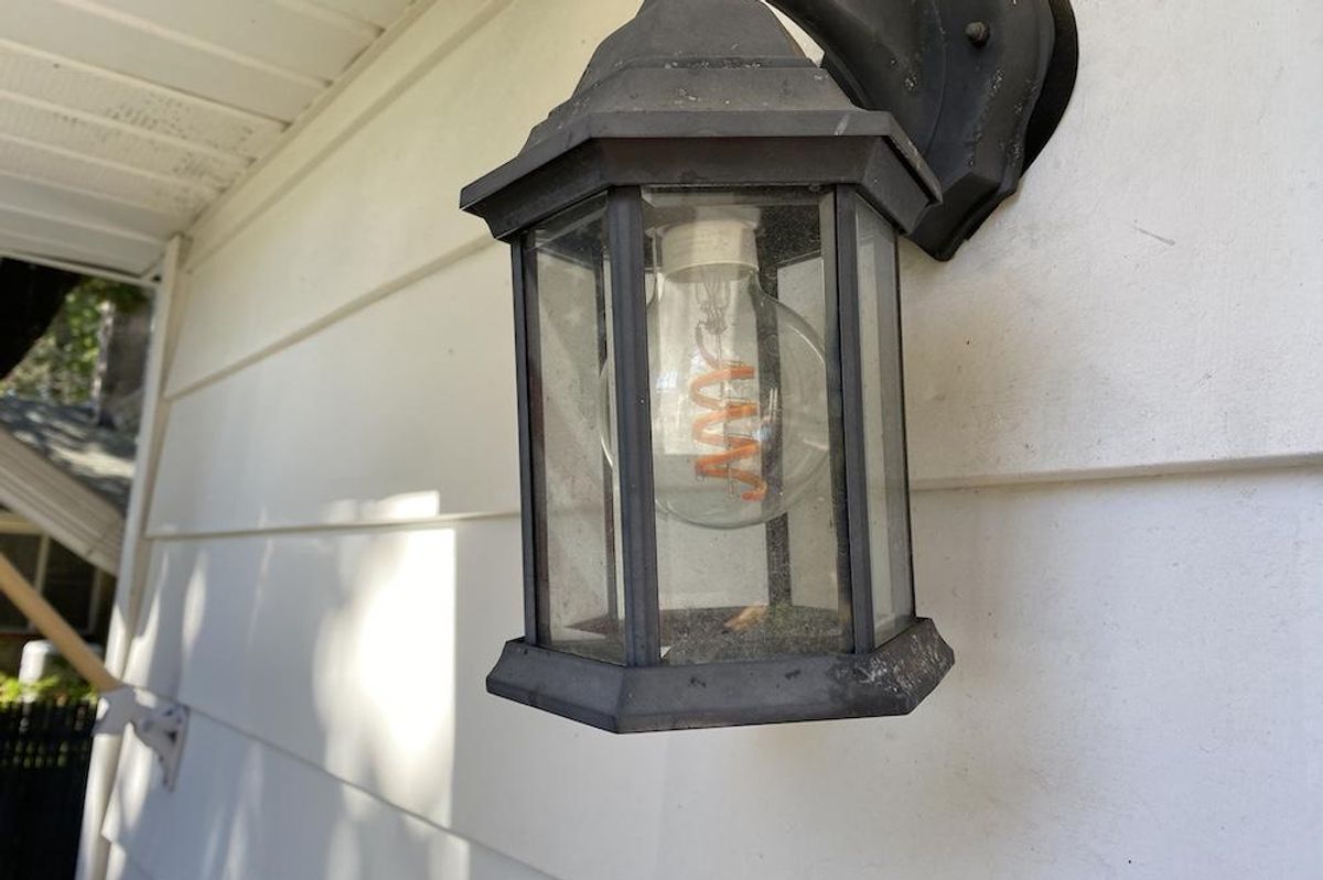 a photo of a Cync Decorative Smart Bulb in a sconce on a home.