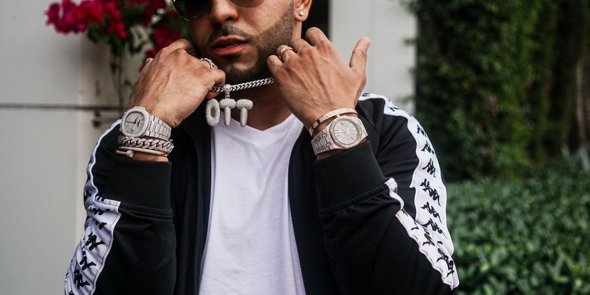 Man showing off expensive, chunky jewelry