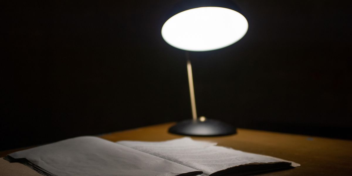 lamp and notebook on desk