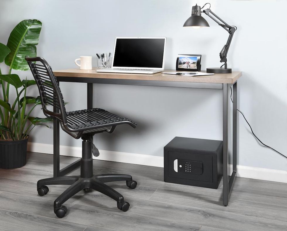 a photo of a desk with the Yale Smart Safe underneath.