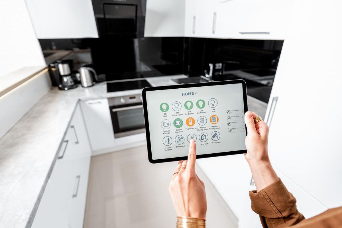 a photo of a tablet controlling a smart kitchen