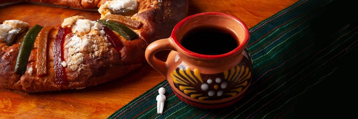 rosca de reyes cafe de olla and baby jesus figurine on a table