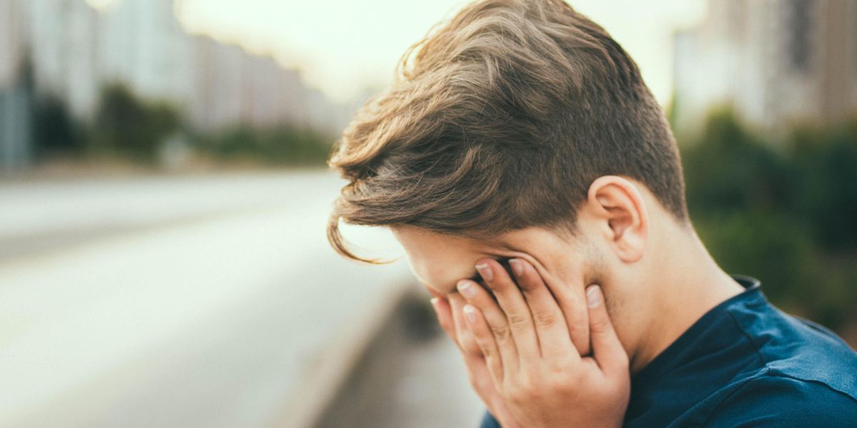 person with their head in their hands