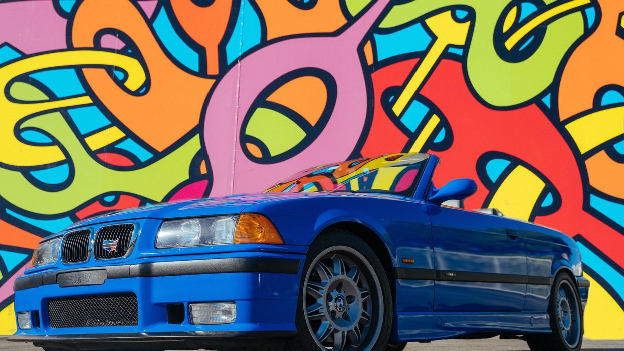 Late '90s Chevy with blue wrap against funky '90s backdrop