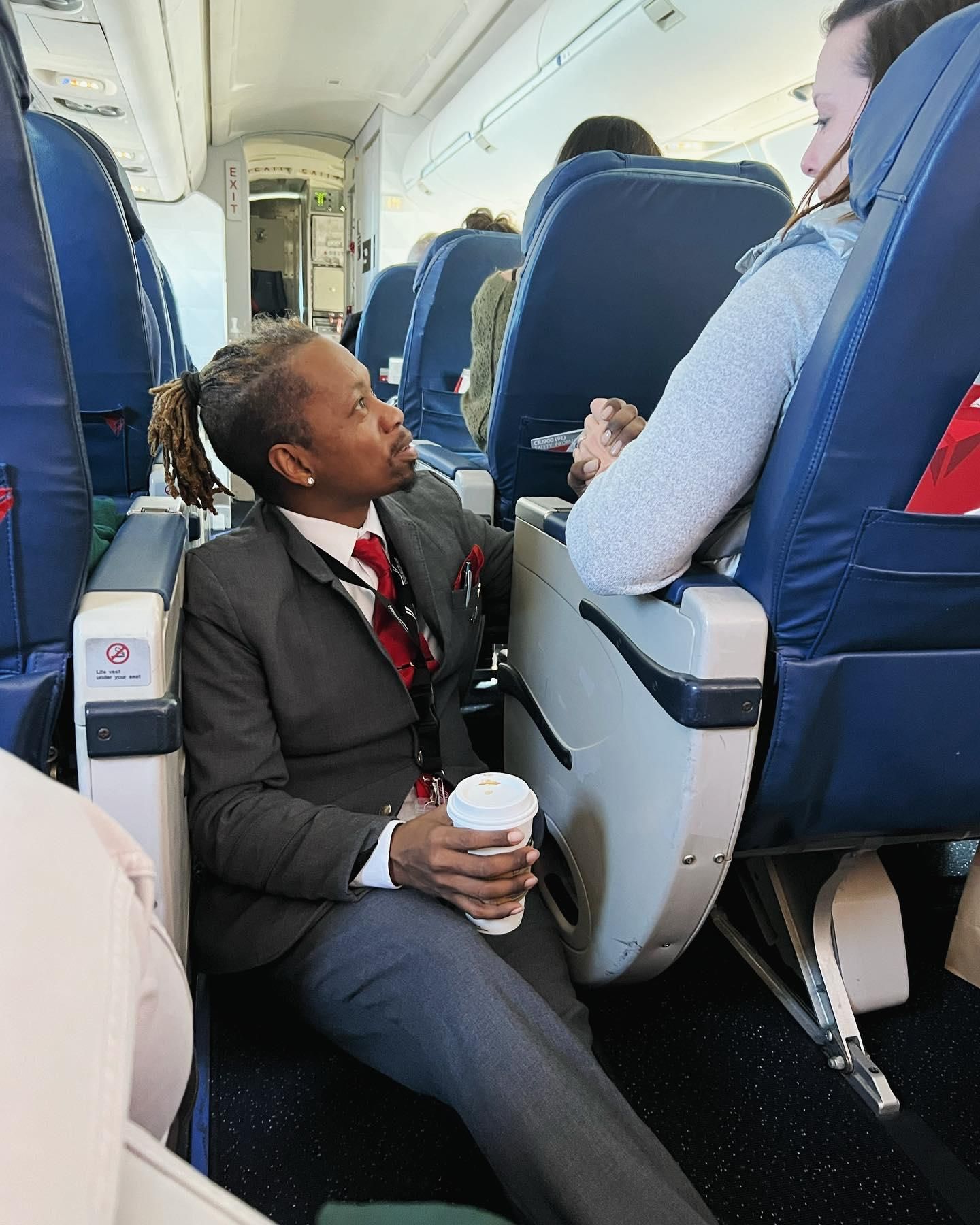 Flight attendant sits on the floor to comfort passenger Upworthy