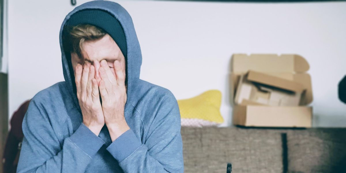 Frustrated man sitting on couch