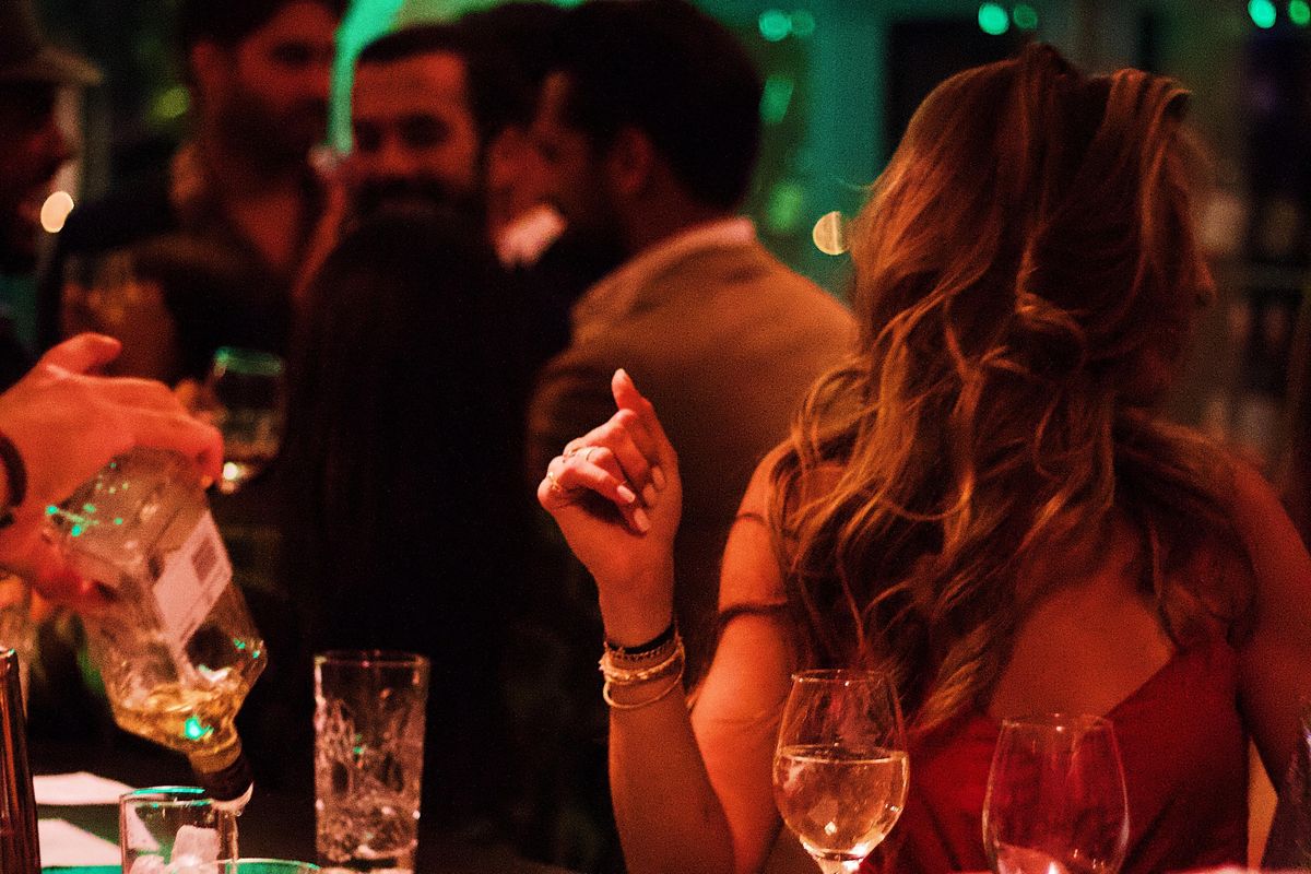 woman sitting in a crowded bar