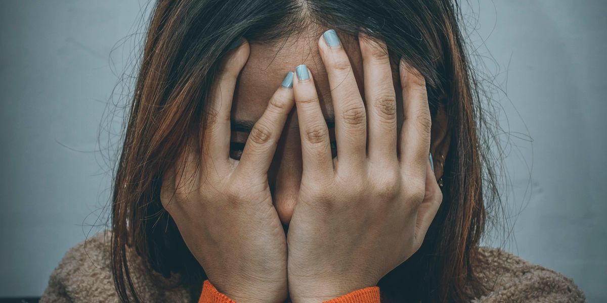 Frustrated woman covering her face