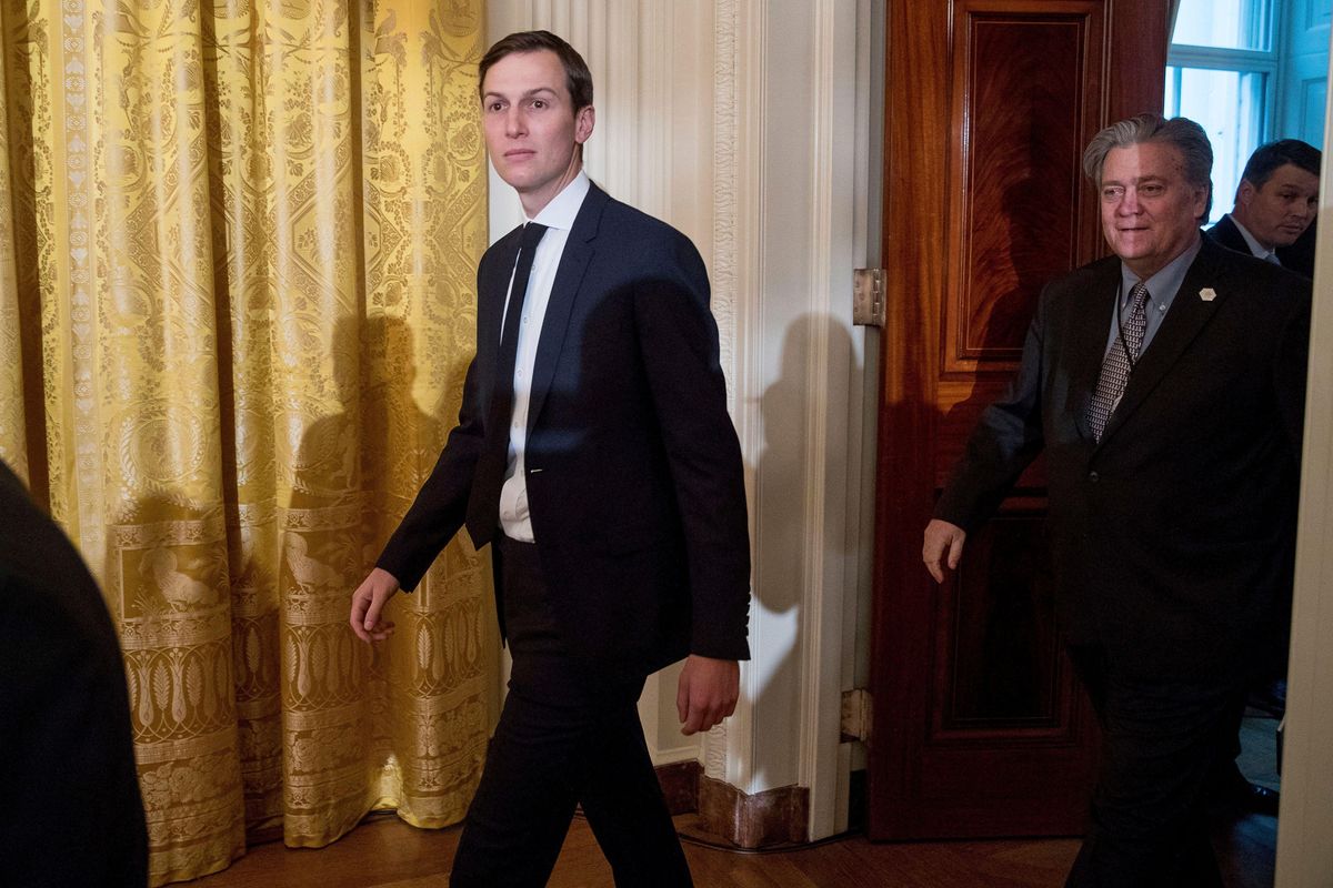Jared Kushner and Steve Bannon arrive at a White House senior staff swearing in ceremony in the East Room of the White House, in Washington. 