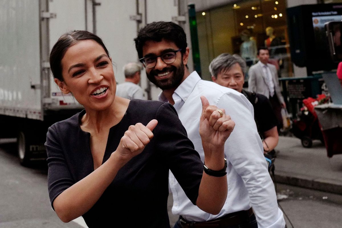 Alexandria Ocasio-Cortez, left, the winner of New York's Democratic Congressional primary, greets supporters following her victory, along with Saikat Chakrabarti, founder of Justice Democrats and senior adviser for her campaign.
