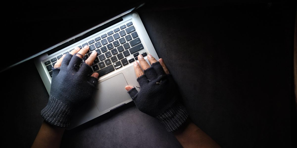 Hacker stealing data on laptop