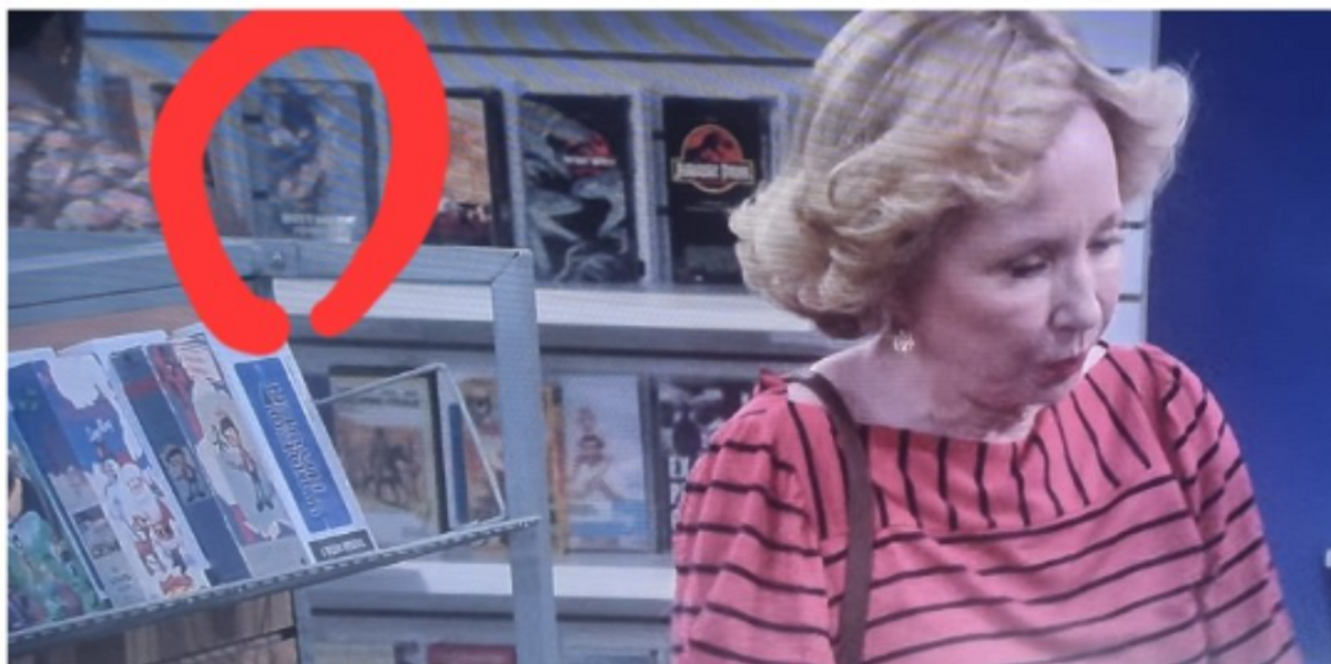 Kitty Foreman in a video store with Batman Forever visible in the background