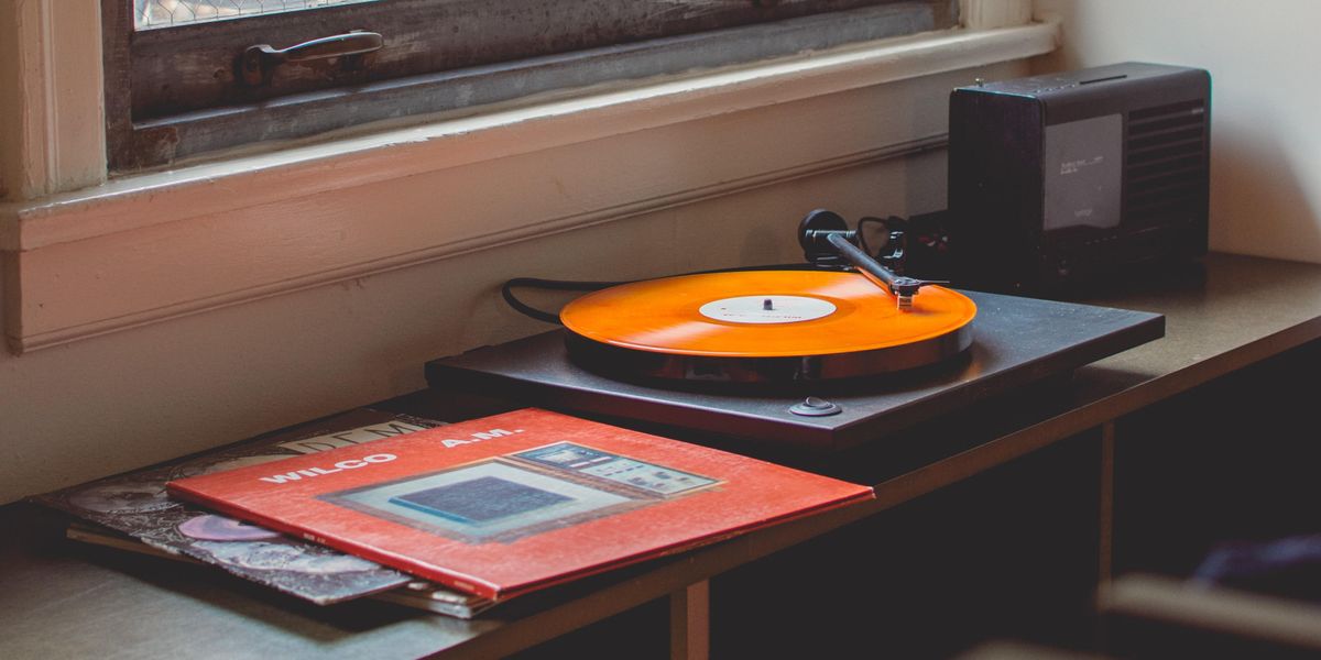 Album and turntable sitting beneath window