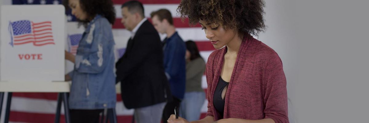 curly haired latina casting her ballot at the voting station