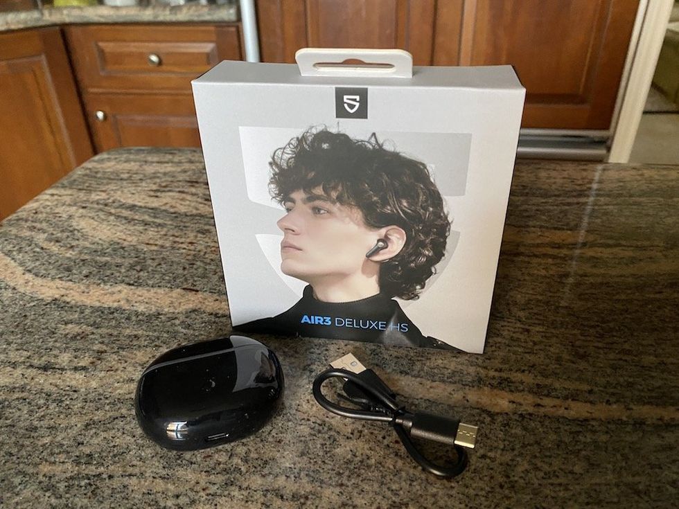 a photo of Soundpeats Air3 Deluxe HS wireless earbuds with charging case and powercord
