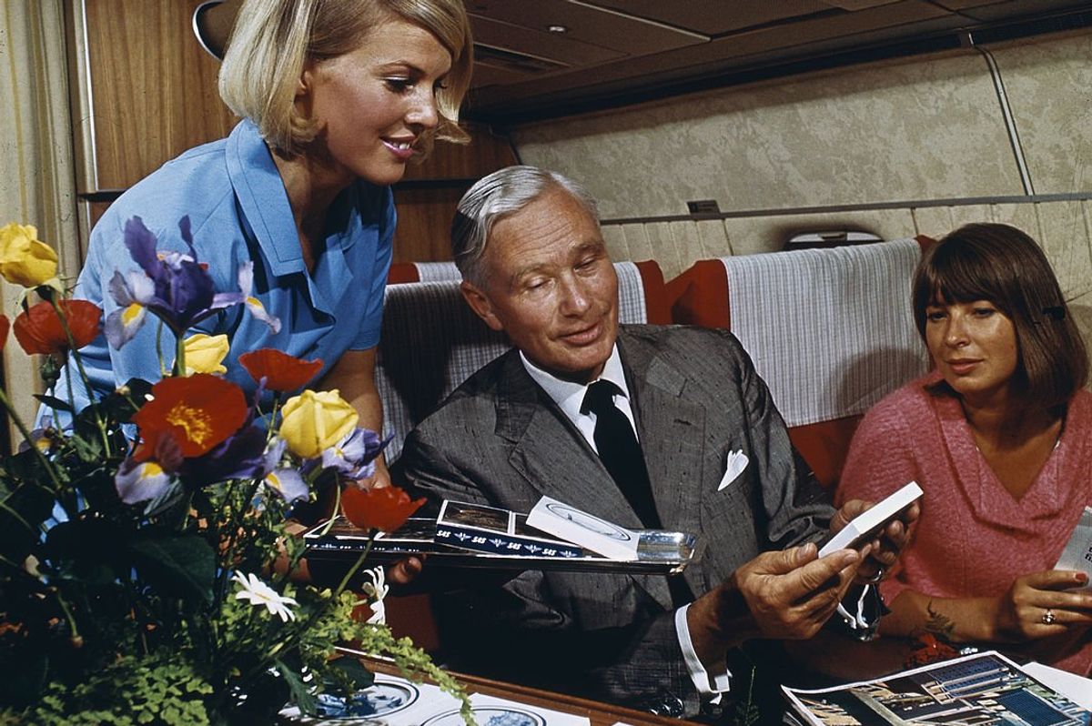stewardess attends to passengers on vintage airline