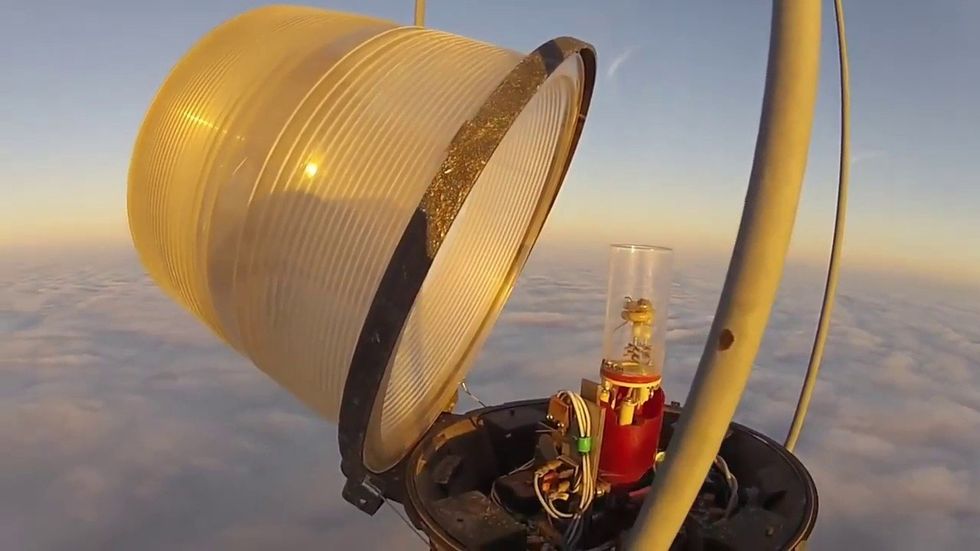 Man climbs a 1,999-foot tower to change a light bulb. It looks just as wild as you'd think.