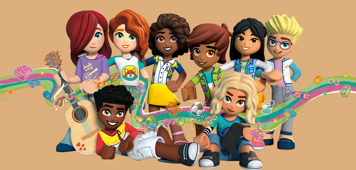 A racially diverse group of 8 LEGO characters are arranged as if posing for a picture, with 6 standing and 2 sitting down in front of the rest of the group.