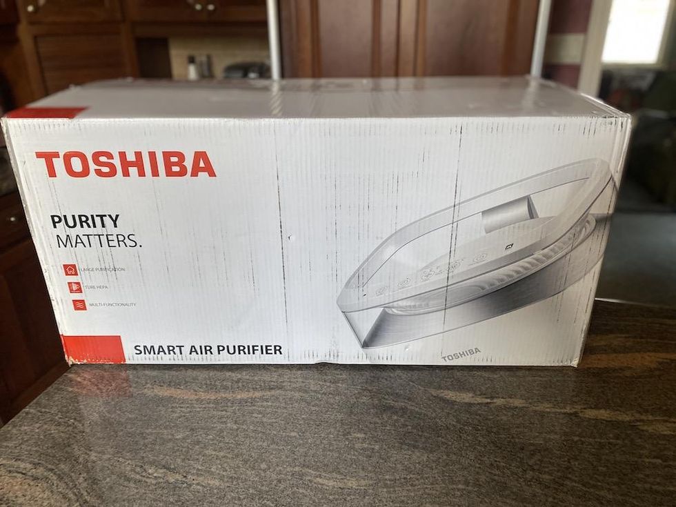a photo of Toshiba Smart Air Purifer in a box on a countertop