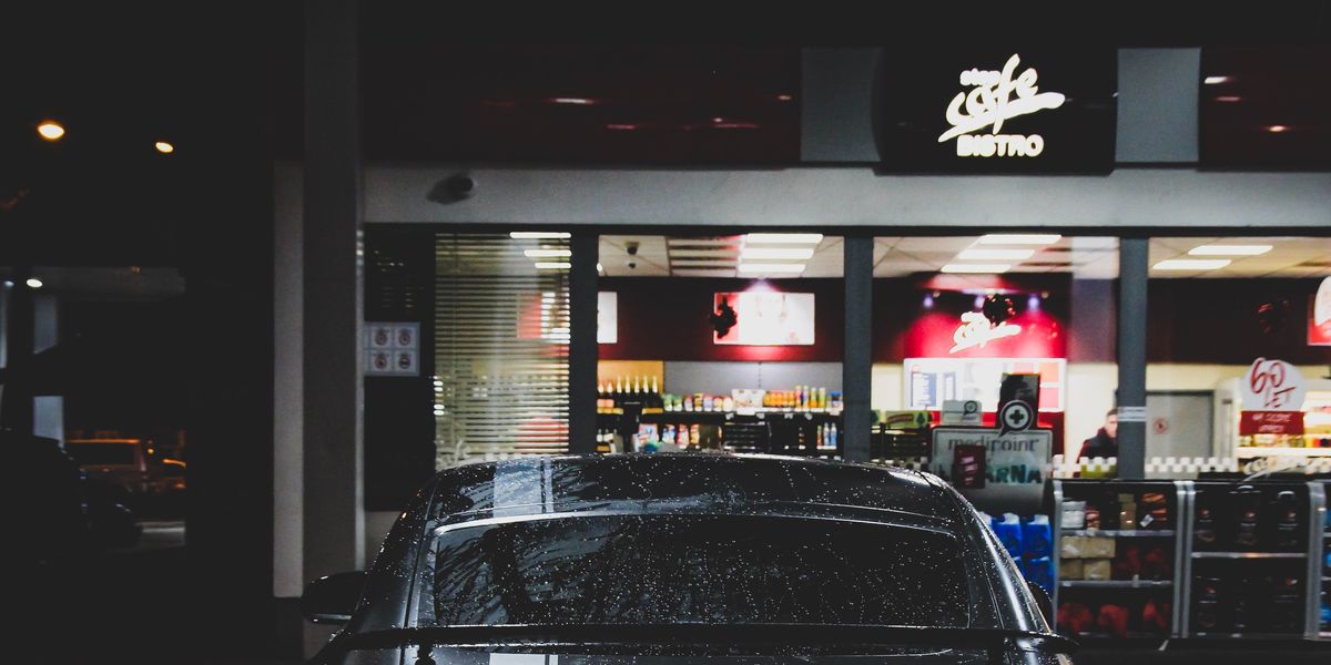 Car parked in front of a convenience store