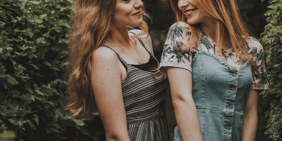 Two women smiling flirtatiously at each other