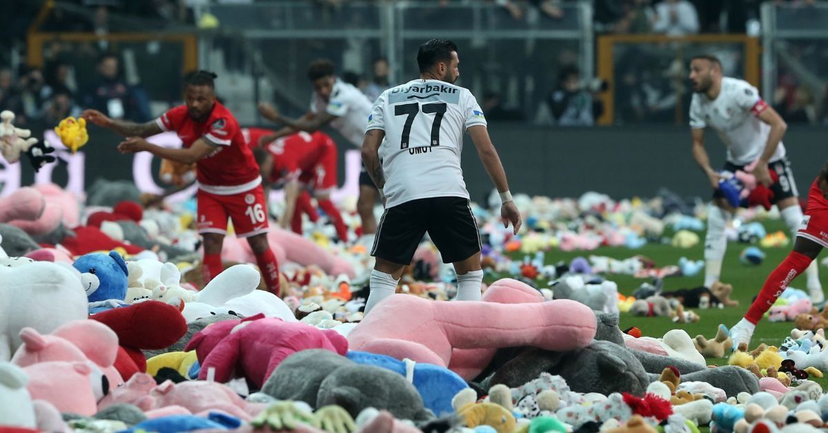 Soccer pitch strewn with thousands of plush animals