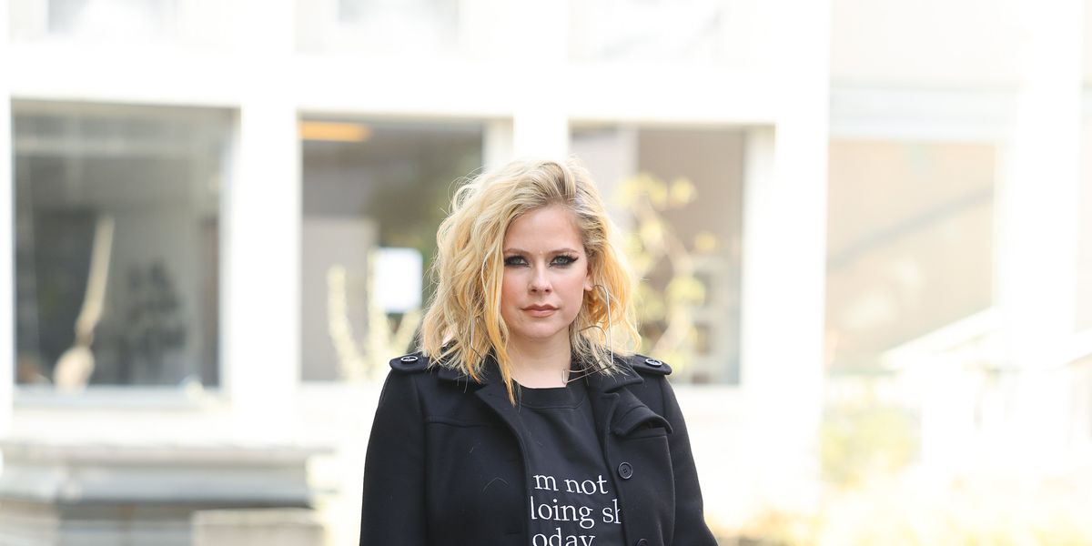 Avril Lavigne leaves event hand-in-hand with pal at Paris Fashion Week  following ex-fiancé split