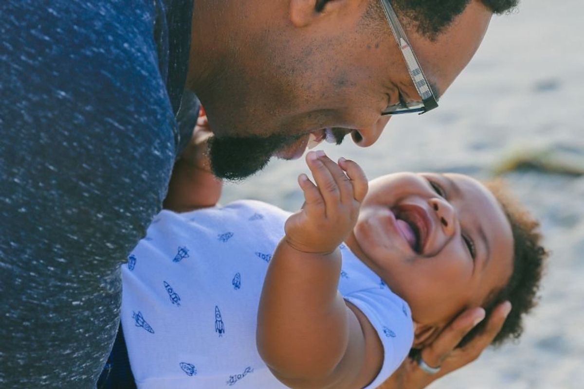 Dad holding laughing baby