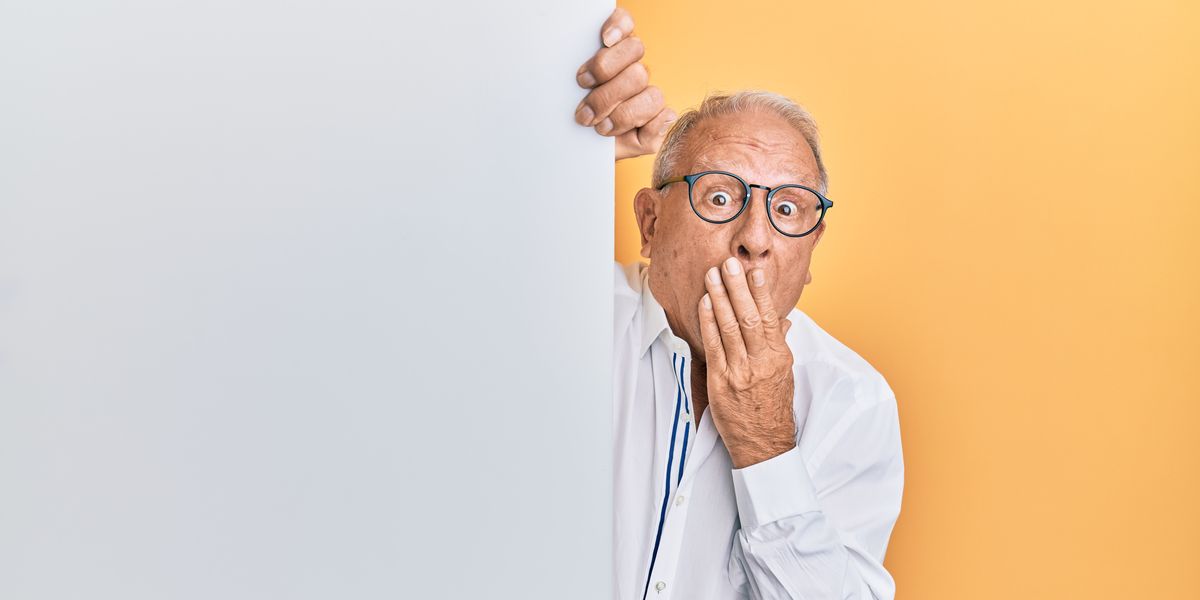 Shocked man peeking around corner