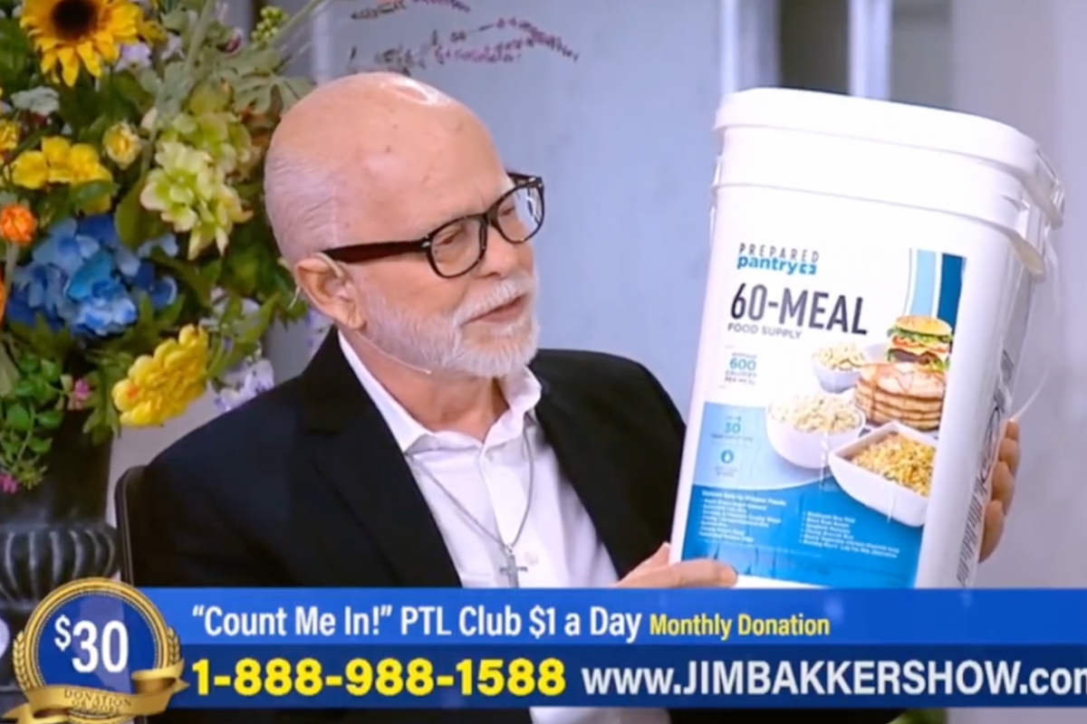 Jim Bakker looks adoringly at 60-meal food bucket