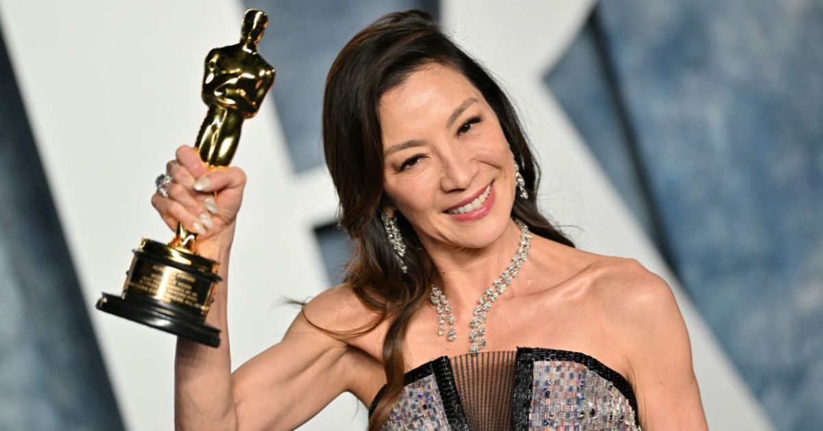 Michelle Yeoh holding her Oscar