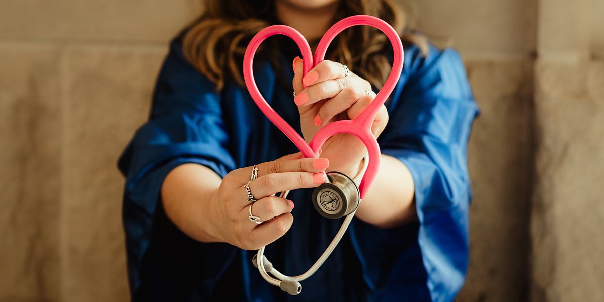 Woman making the shape of a heart with a stethoscope