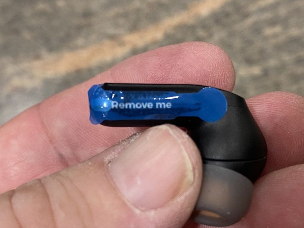 a photo of Soundpeats Capsule3 Pro earbud with blue tape cover battery sensor on earbud