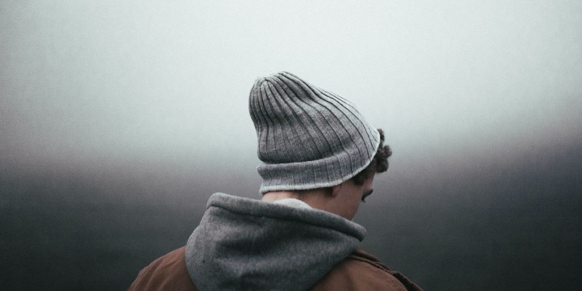 Man in knit cap looking sad