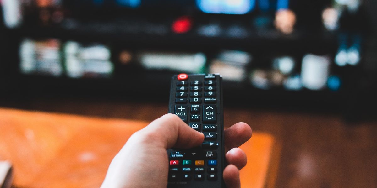 Person aiming a remote at a TV