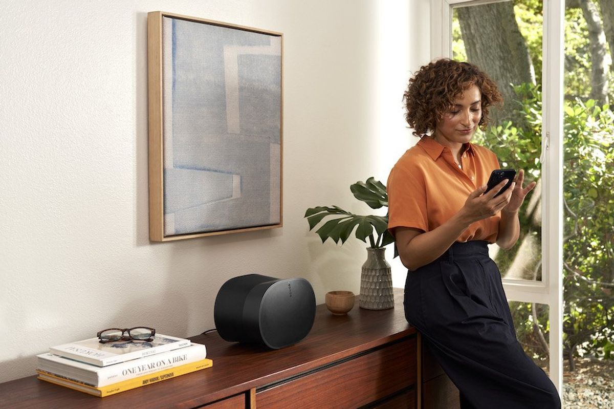 a photo of a woman in a bedroom with Sonos Era 300 smart speaker