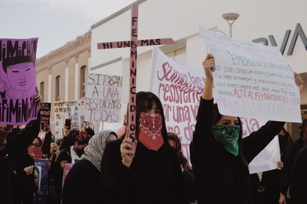 Pink cross with the words \u201cnot one more\u201d and \u201cfemicides\u201d written on it, seen on a Women\u2019s Day march in Ciudad Ju\u00e1rez, Chihuahua.