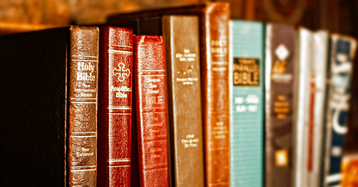 Different Bibles on a bookshelf
