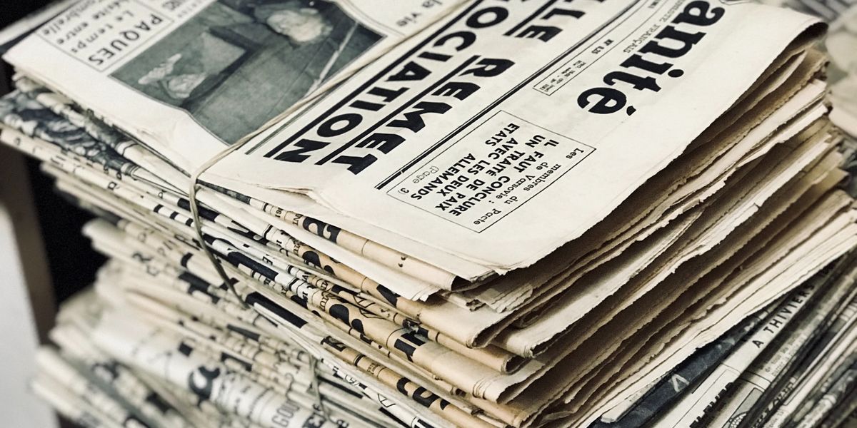A bundle of old, yellowed newspapers