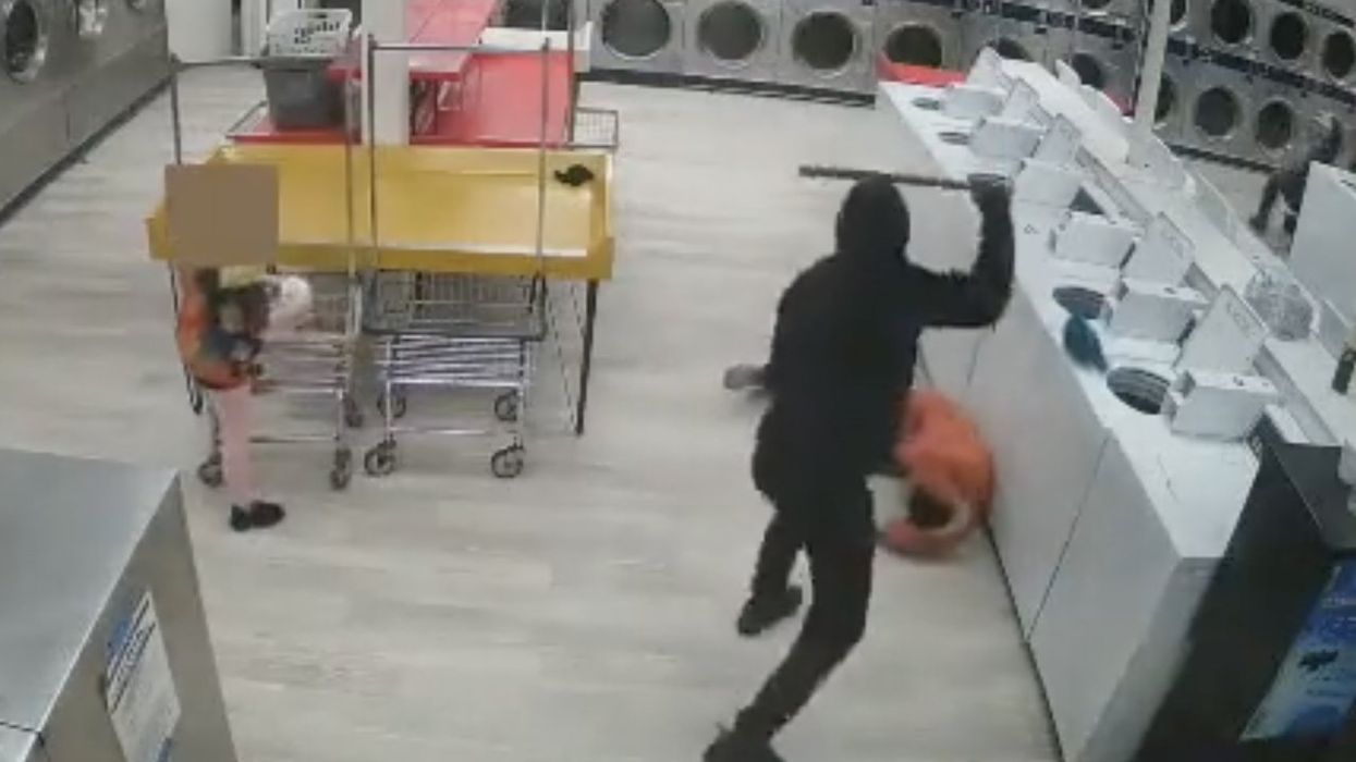 Video: Hooded thug sneaks up behind man, repeatedly bashes him in head in unprovoked laundromat attack Video: Hooded thug sneaks up behind man, repeatedly bashes him in head in unprovoked laundromat attack