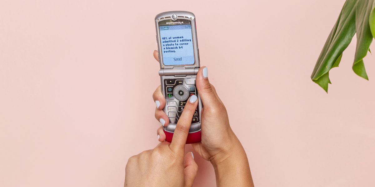 Person texting with silver flip phone