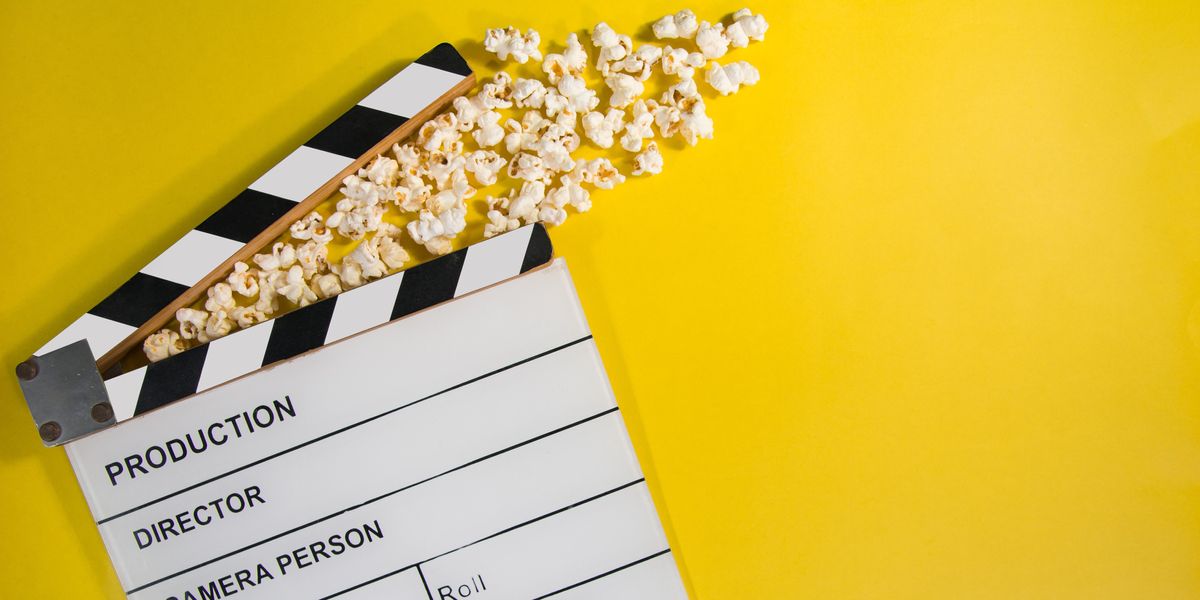Black and white film production clapperboard with movie theater popcorn