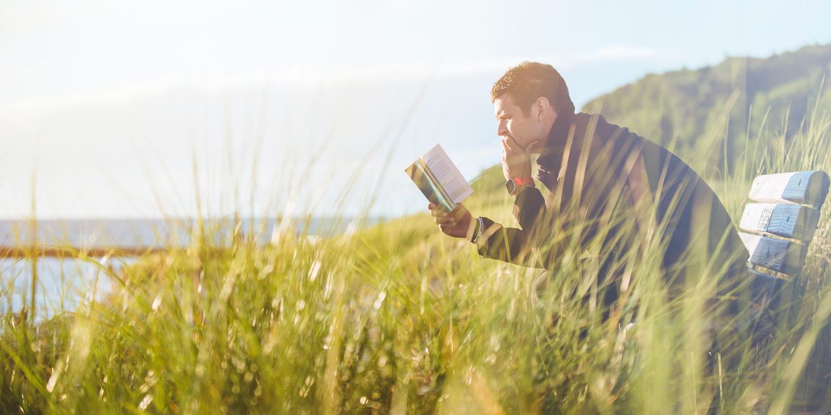 Man reading book in nature