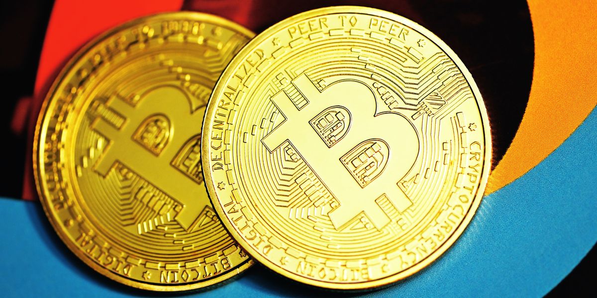 gold round coin on blue textile