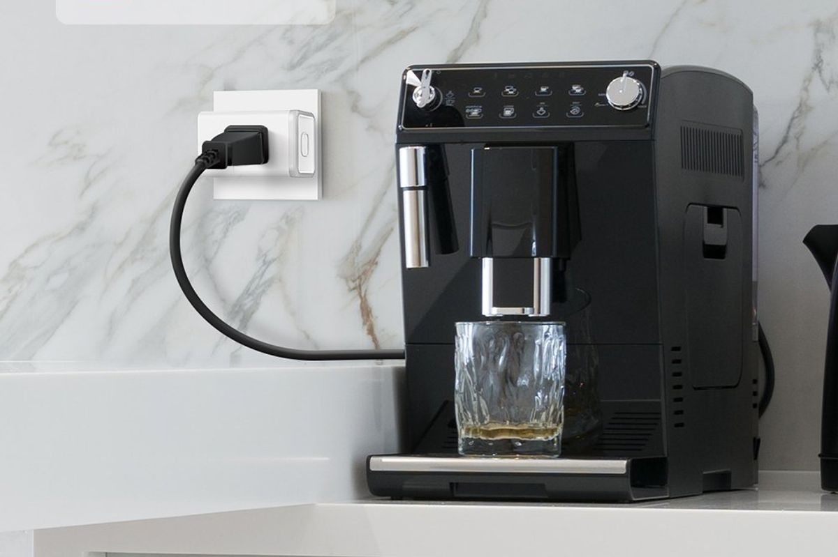 a photo of a coffice machine plugged into a smart plug