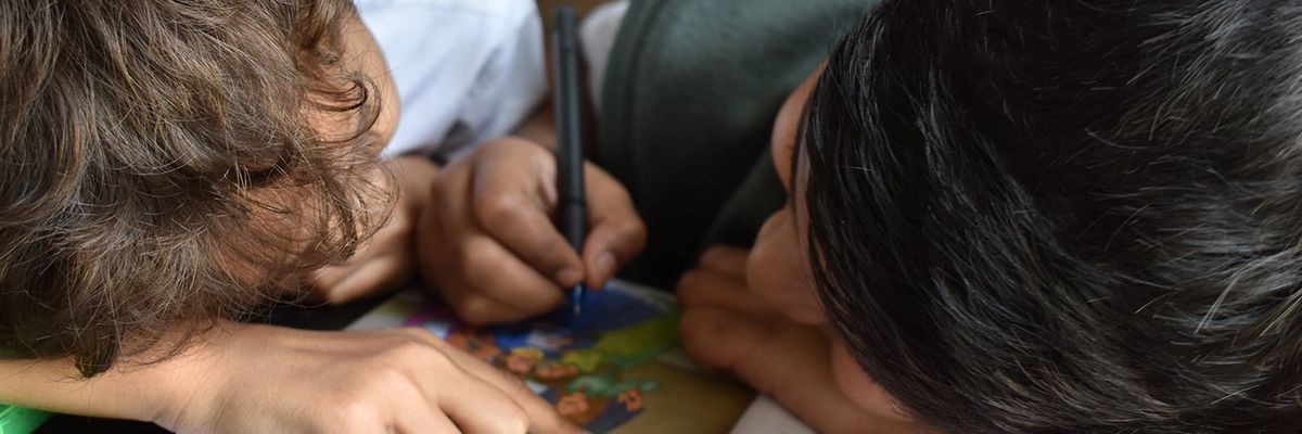 two children drawing together