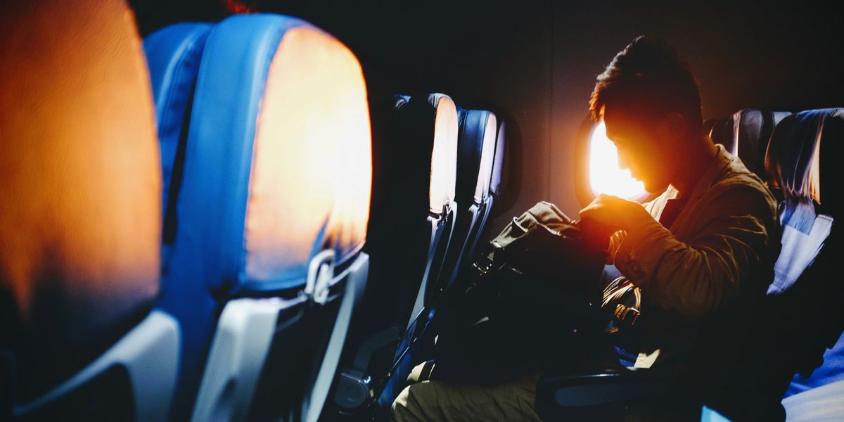 Male flight passenger looking through his bag
